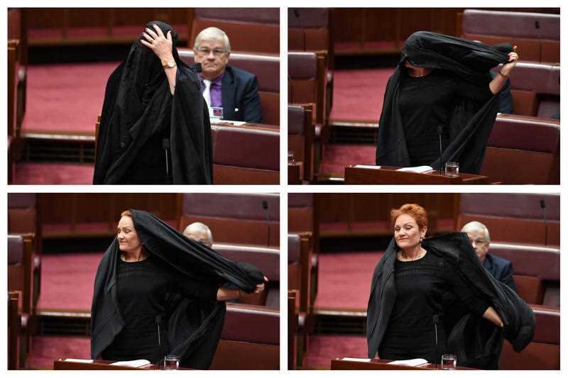 One Nation Senator Pauline Hanson takes off a burqa in the Senate.