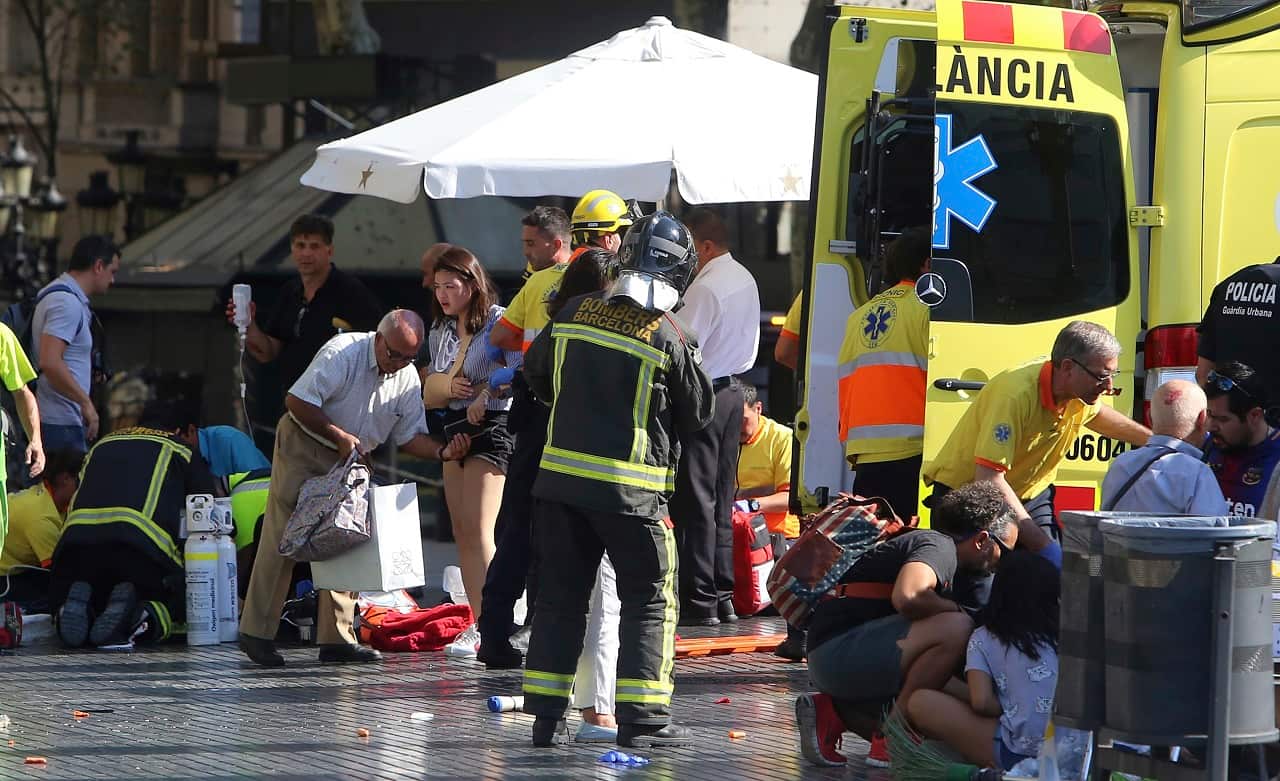 Injured people are treated after a white van jumped the sidewalk in the historic Las Ramblas district.