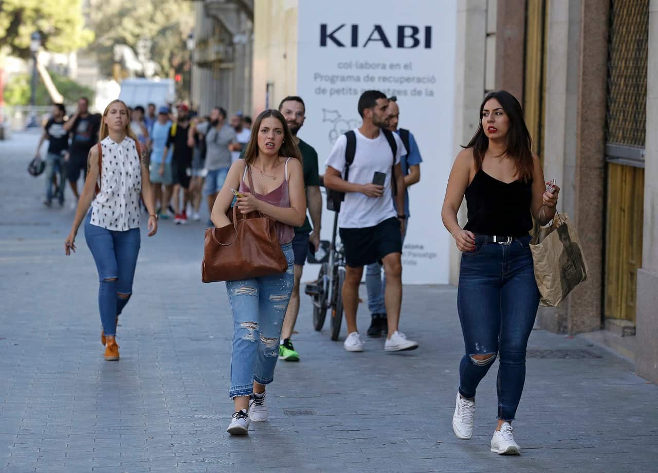 People run down a street in Barcelona, Spain, after the attack.
