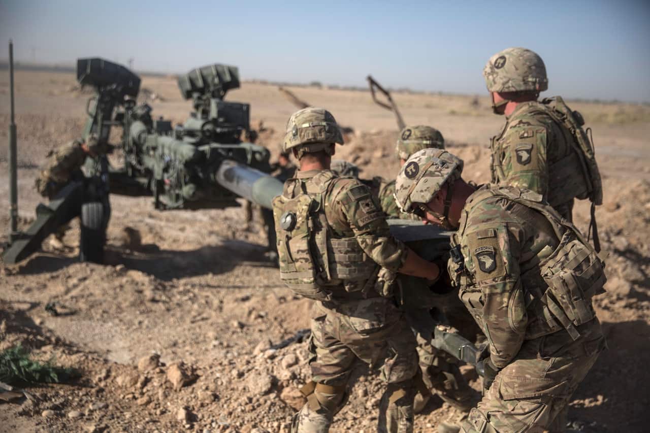 U.S. Soldiers with Task Force Iron maneuver an M-777 howitzer, so it can be towed into position at Bost Airfield, Afghanistan.