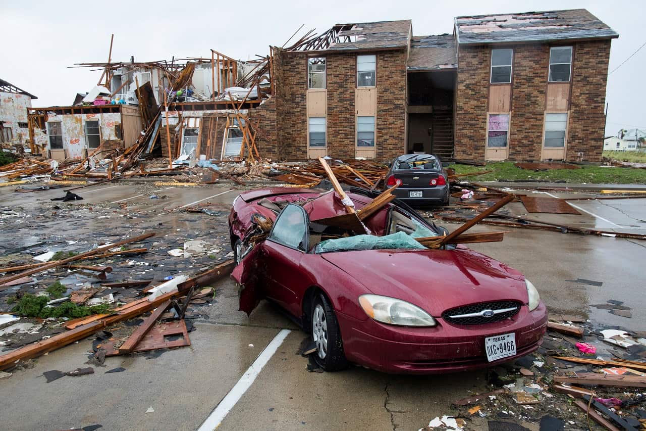 A damaged car sits outside a heavily damaged apartment complex in Rockport, Texas, in the wake of Hurricane Harvey.