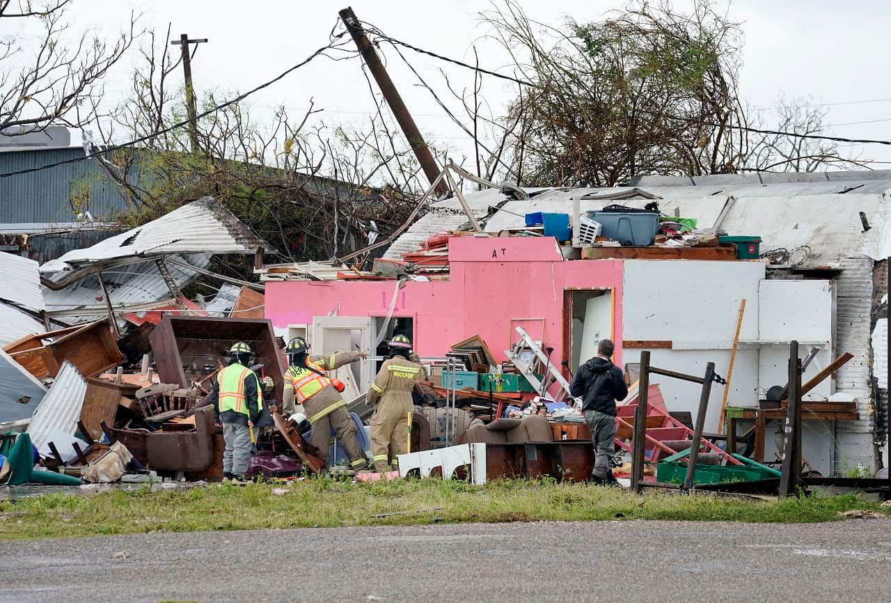 Rescue workers search for survivors in a structure damaged by Hurricane Harvey in Rockport, Texas, 26 August 2017.