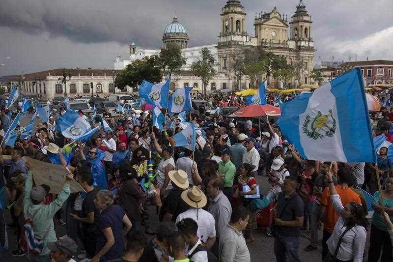 People gather to protest Guatemala's President Jimmy Morales outside the National Palace of Culture in Guatemala City