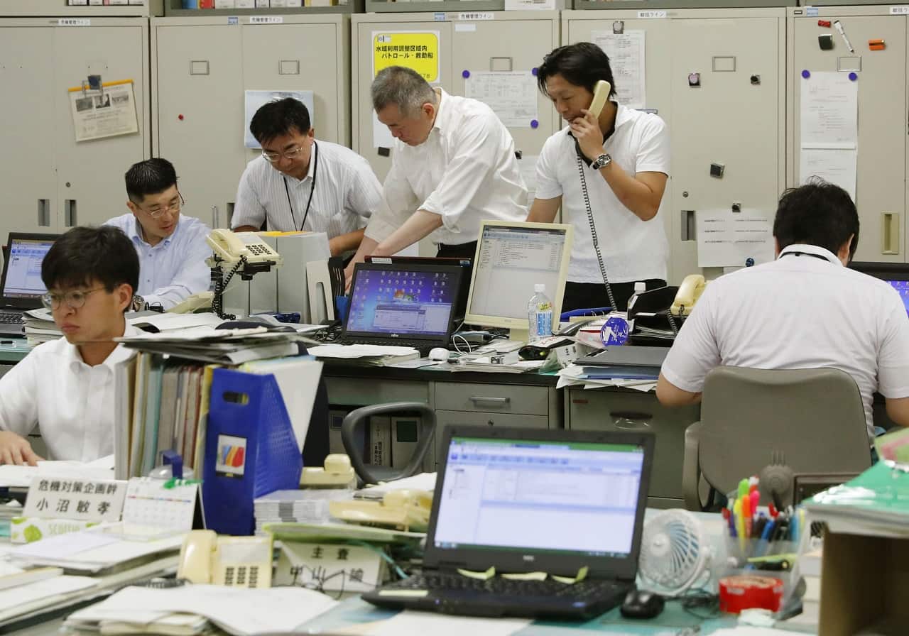 Hokkaido officials react at the local government building in Sapporo on Aug 29 2017 after a North Korean ballistic missile passed over Japan.