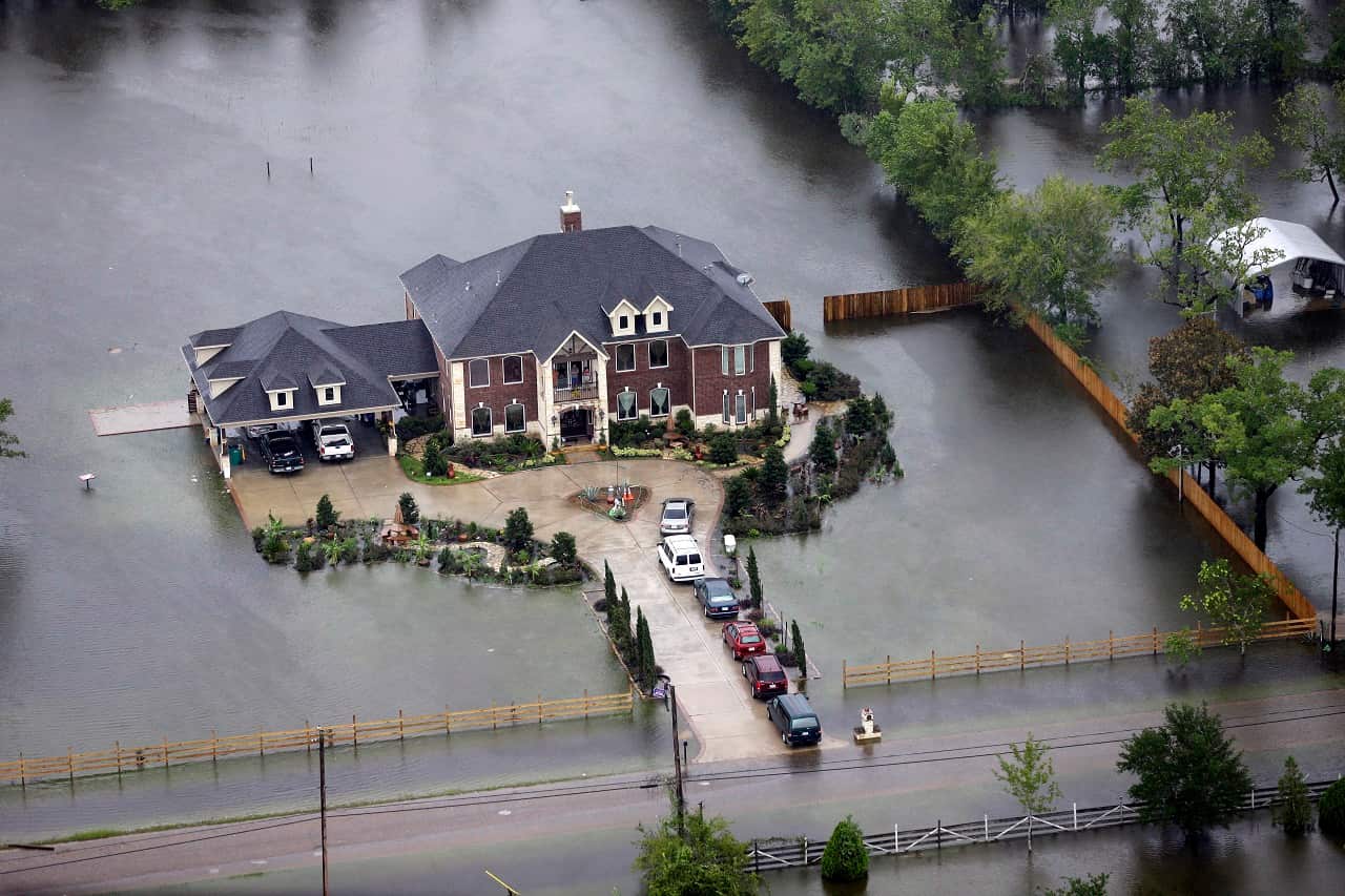 A home is surrounded by floodwaters from Tropical Storm Harvey on Tuesday, Aug. 29, 2017, in Houston. 