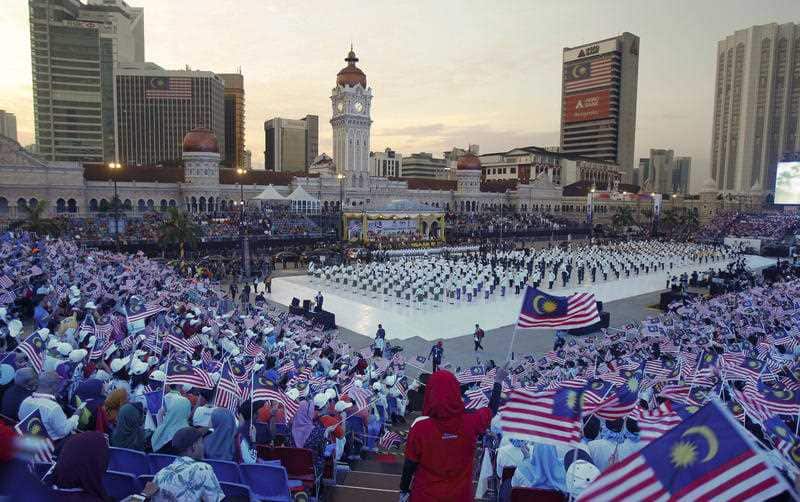 Malaysian students wave Malaysia flags during the 60th Independence Day celebrations at the Independence Square in Kuala Lumpur, Malaysia. 