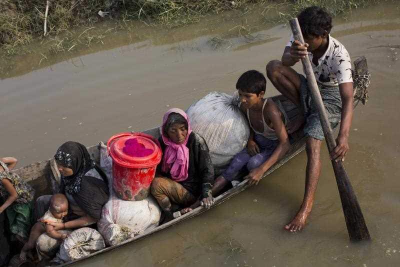 A Rohingya family piles on their meagre belongings on to boat they hired to bring them deeper inside Bangladesh.