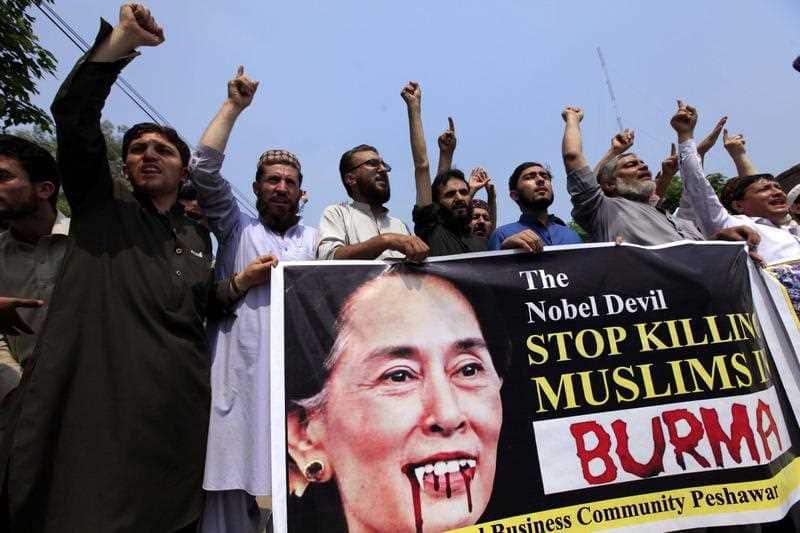 People hold a banner with picture of Myanmar democracy leader Aung San Suu Kyi on, during a protest against violence in Myanmar, in Peshawar, Pakistan, 07 September 2017.