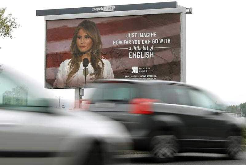 Cars drive in front of a huge advert poster of the 'American Institute' promoting its English language courses with a photo of US First Lady Melania Trump, in downtown Zagreb, Croatia, 16 September 2017.