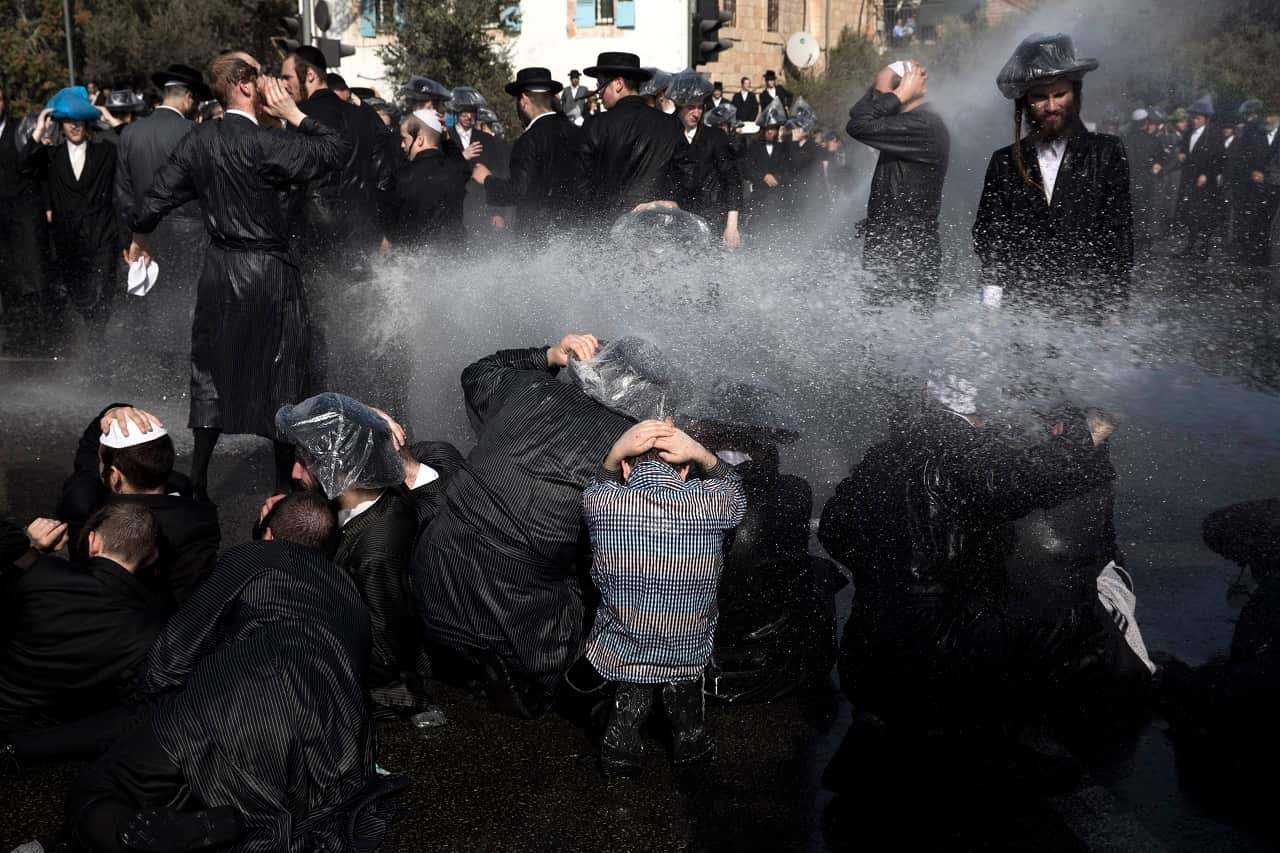 Israeli police use water cannon to disperse Ultra-Orthodox Jewish demonstrators as they protest against army recruitment