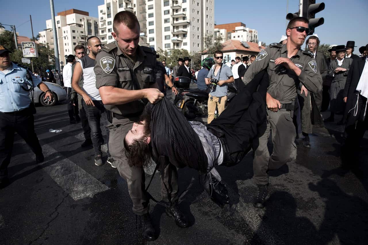 Israeli Border Police arrest an Ultra-Orthodox Jewish demonstrators as they protest against army recruitment in Jerusalem,