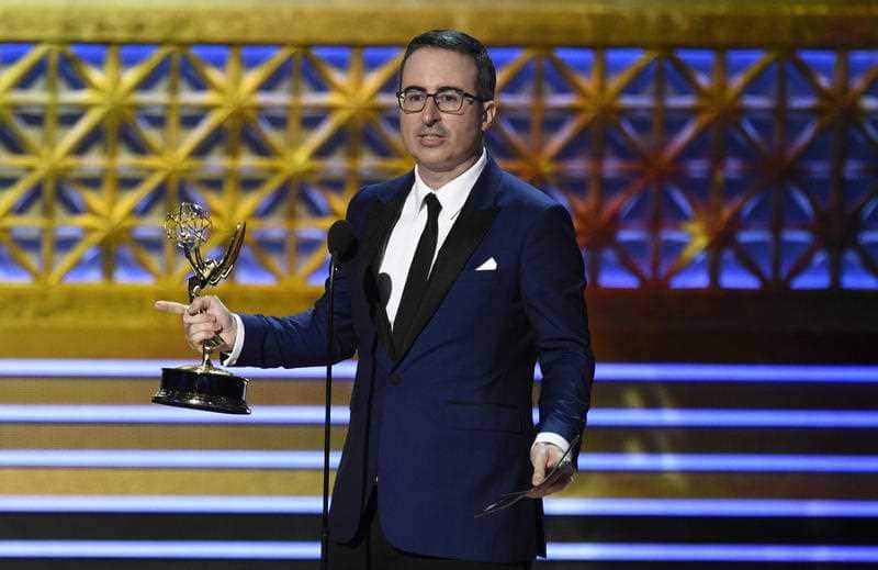 John Oliver accepts the award for outstanding writing for a variety series for "Last Week Tonight with John Oliver".