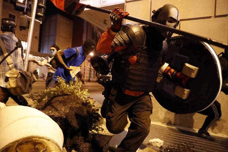 People run after vandalizing as demonstrators march in response to a not guilty verdict in the trial of former St. Louis police officer Jason Stockley.