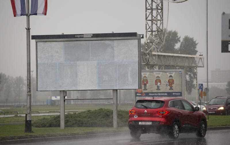 Cars drive past the empty advertising space from which a billboard depicting the first lady Melania Trump was removed, in Zagreb, Croatia, Tuesday, Sept. 19, 2017.