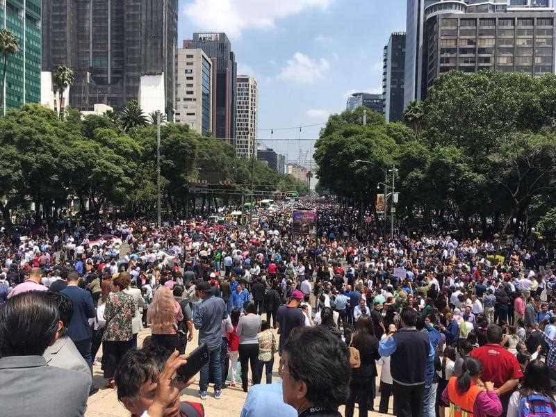 People fill Paseo de la Reforma after evacuating from their offices after an earthquake in Mexico City, Tuesday, Sept. 19, 2017.