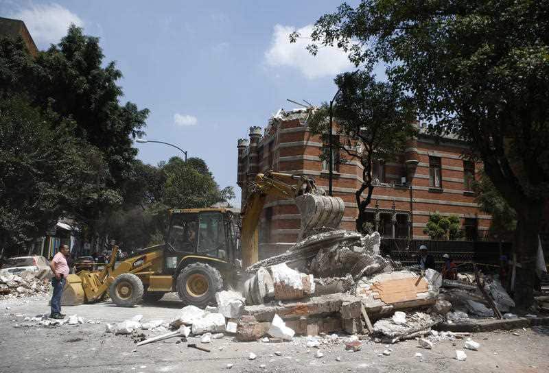 A bulldozer removes debris from a partially collapsed building after an earthquake in Mexico City, Tuesday, Sept. 19, 2017.