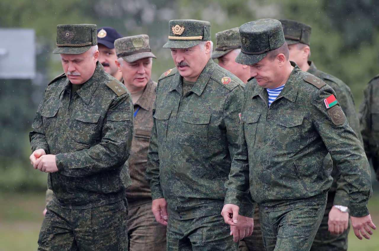 Belarus' President Alexander Lukashenko, center, arrives to attend the Zapad (West) 2017 joint Russia-Belarus military drills at Borisovsky range in Borisov, Belarus, on Wednesday, Sept. 20, 2017. (AP Photo/Sergei Grits)