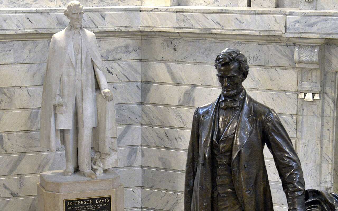 A statue of Jefferson Davis, left, faces a statue of Abraham Lincoln in Frankfort, Kentucky.