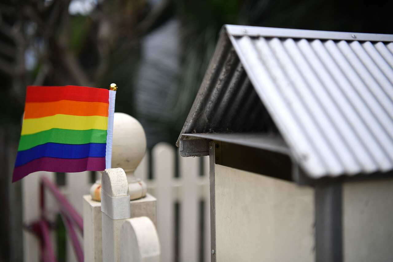 A rainbow flag in support of a Yes vote in the marriage equality postal survey is seen on a fence in Sydney's inner west, Tuesday, October 3, 2017. (AAP Image/Joel Carrett) NO ARCHIVING