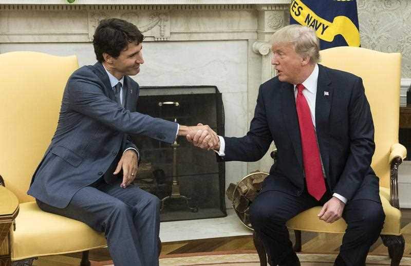 US President Donald J. Trump (R) shakes hands with Canadian Prime Minister Justin Trudeau during a meeting in the Oval Office.