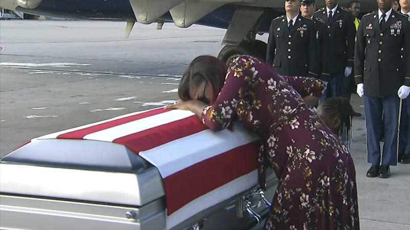 Myeshia Johnson cries over the casket in Miami of her husband, Sgt. La David Johnson, who was killed in an ambush in Niger.