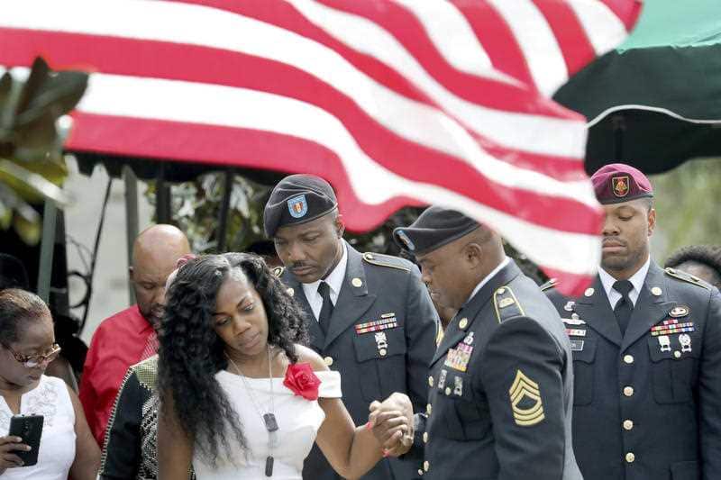 Myeshia Johnson, the wife of Army Sgt. La David Johnson, looks down at his casket after his burial at the Hollywood Memorial Gardens in Hollywood, Florida