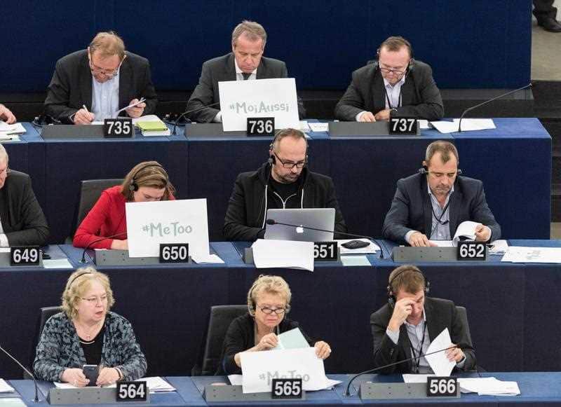 European Parliament member of the group of the Greens/European Free Alliance sit behind placards with the hashtag 'MeToo' during a debate to discuss preventive measures against sexual harassment and abuse in the EU at the European Parliament.