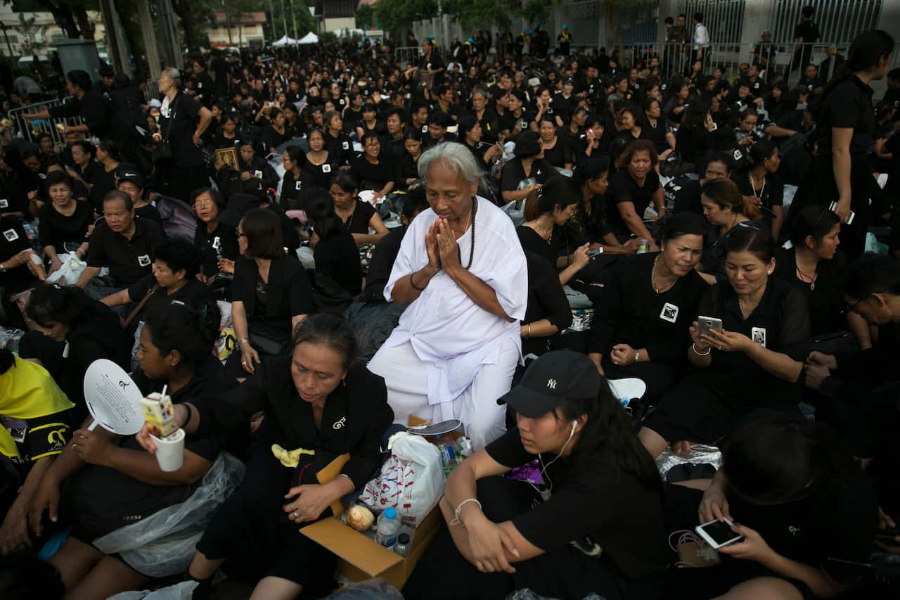 Thai mourners pray for the late King Bhumibol Adulyadej as they take part in the Royal Cremation ceremony in Bangkok, Thailand, Wednesday, Oct. 25, 2017.