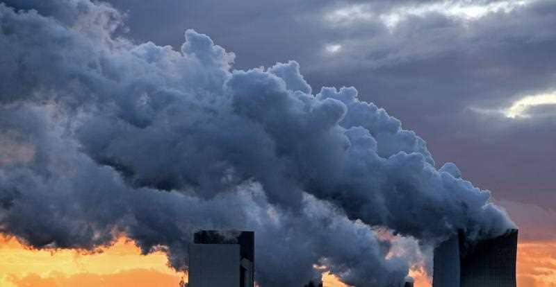 Water vapor rises from a cooling towers of the lignite-fired power station in Boxberg, Germany.