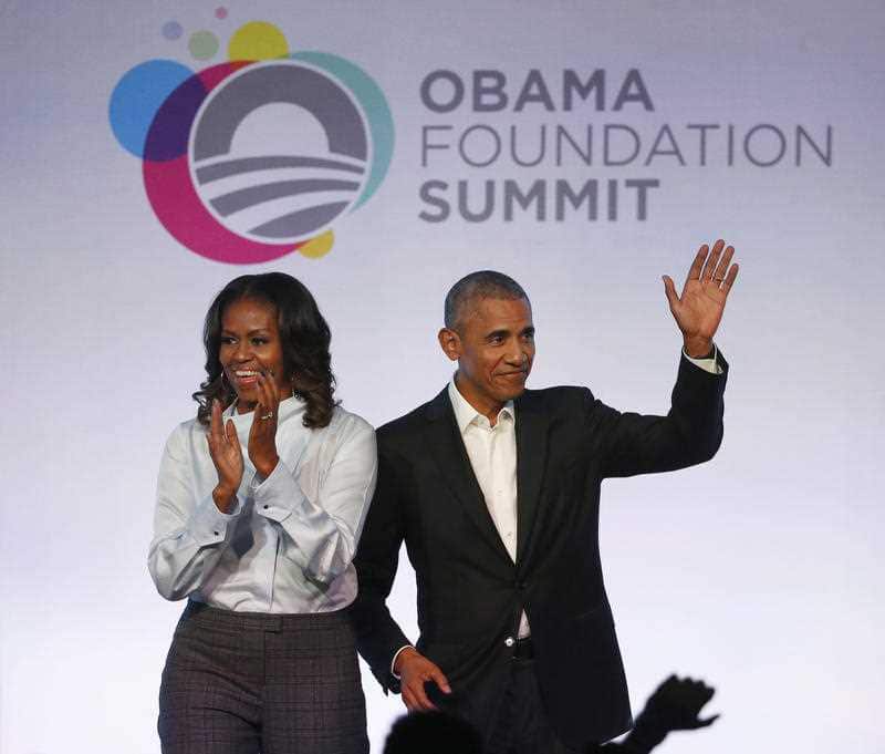 Former President Barack Obama, right, and former first lady Michelle Obama arrive for the first session of the Obama Foundation Summit Tuesday, Oct. 31, 2017, in Chicago.