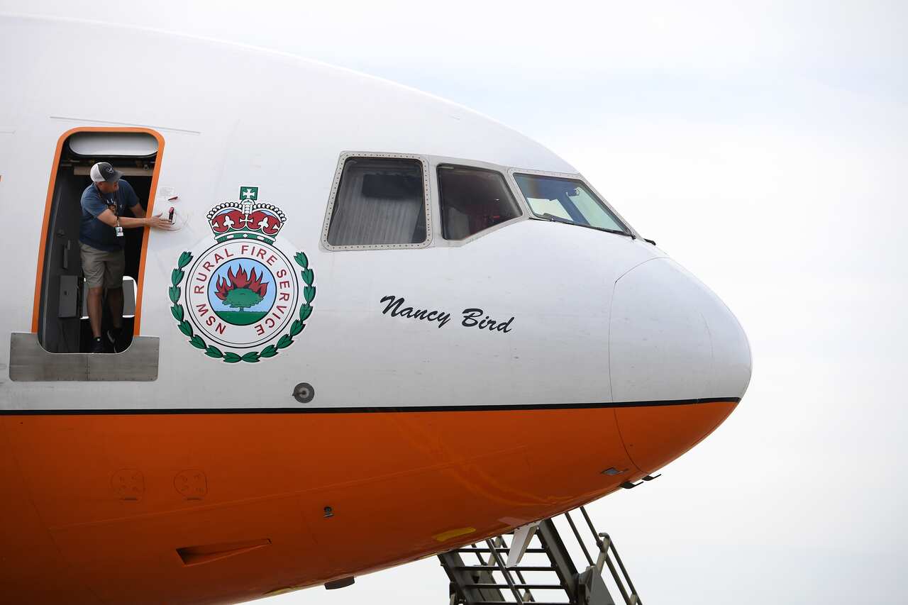 An aircrew member makes final checks on a NSW Rural Fire Service Very Large Air Tanker (VLAT) prior to departing for a water drop test.