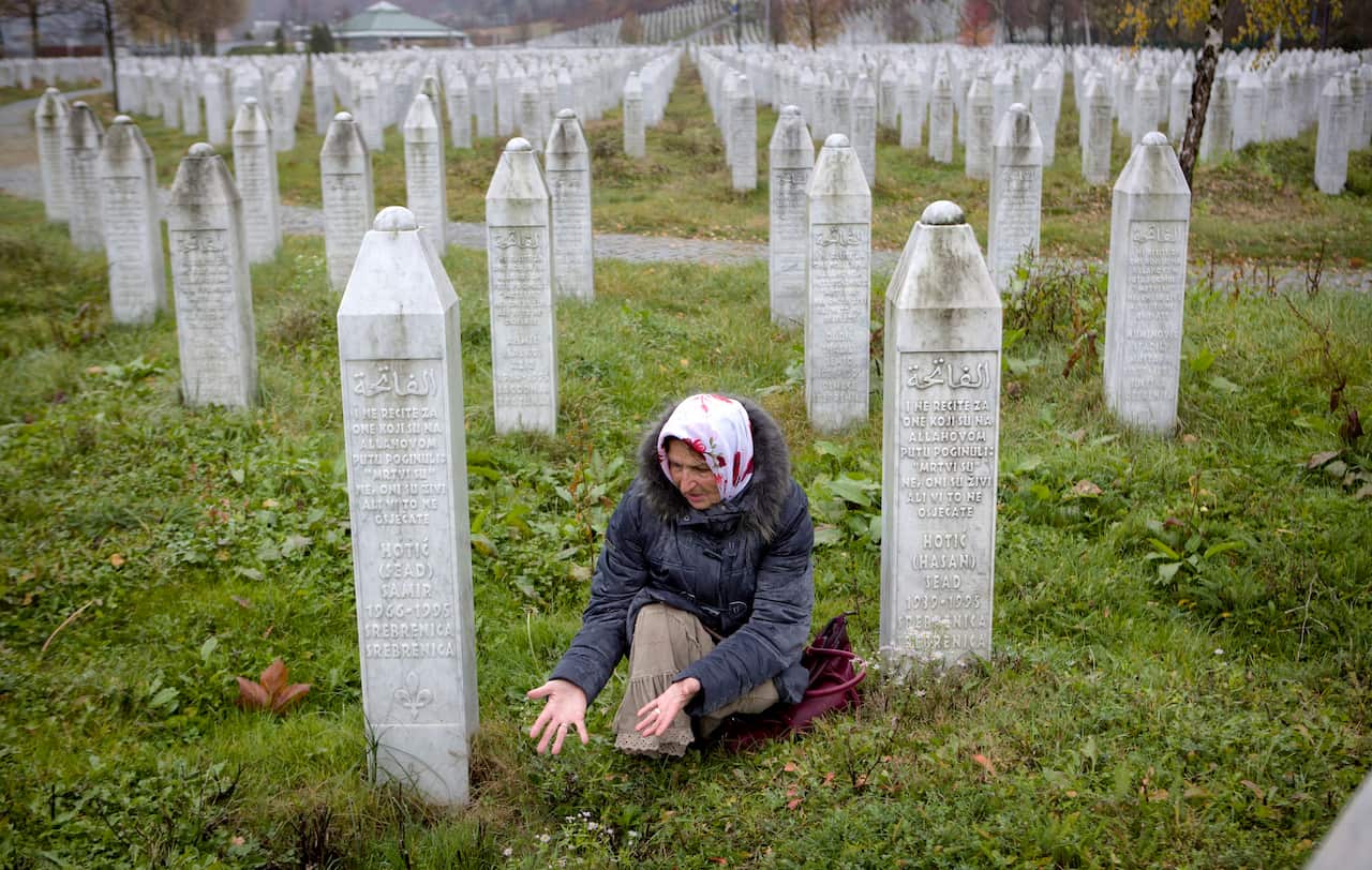 (File Image) A woman gestures near grave stones at the memorial centre of Potocari near Srebrenica.