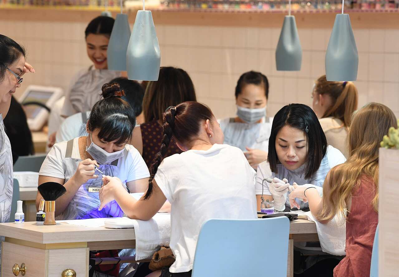 Customers receive manicures at a nail salon in Townsville, Friday, Nov. 10, 2017. (AAP Image/Dave Hunt) NO ARCHIVING