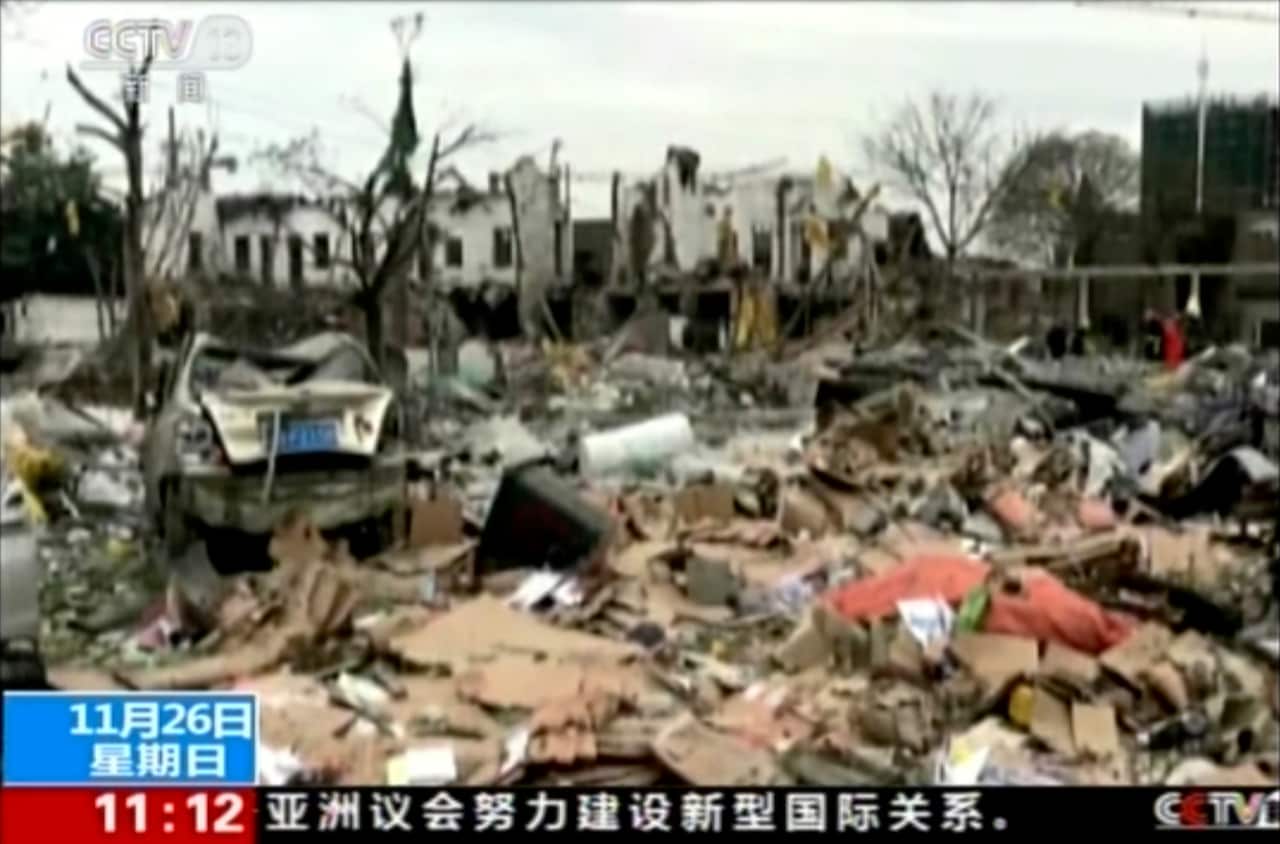 The explosion knocked down buildings and left streets littered with damaged cars and debris.