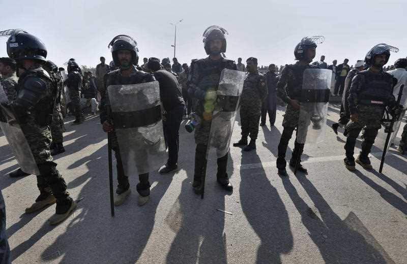 Pakistani paramilitary troops stand guard near a venue of a sit-in protest by a religious radical party in Islamabad, Pakistan, Monday, Nov. 27, 2017.