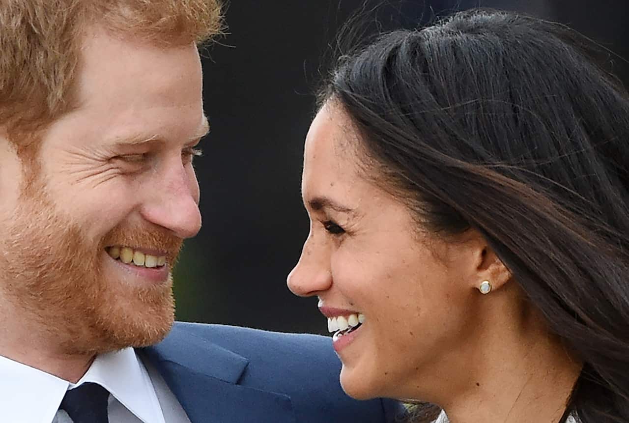 Prince Harry (L) poses with his fiancee, US actress Meghan Markle during a photocall after announcing their engagement