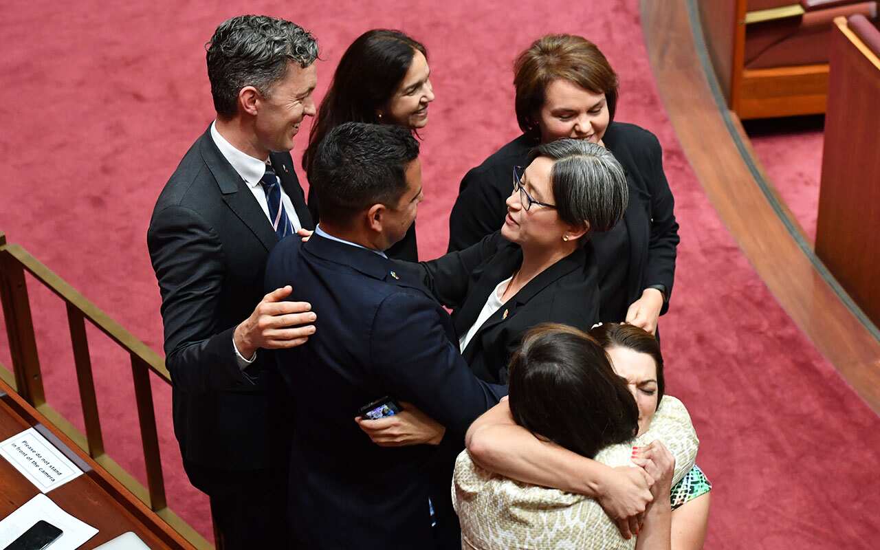 Shadow Minister for Foreign Affairs Penny Wong and fellow marriage equality supporters after the vote.