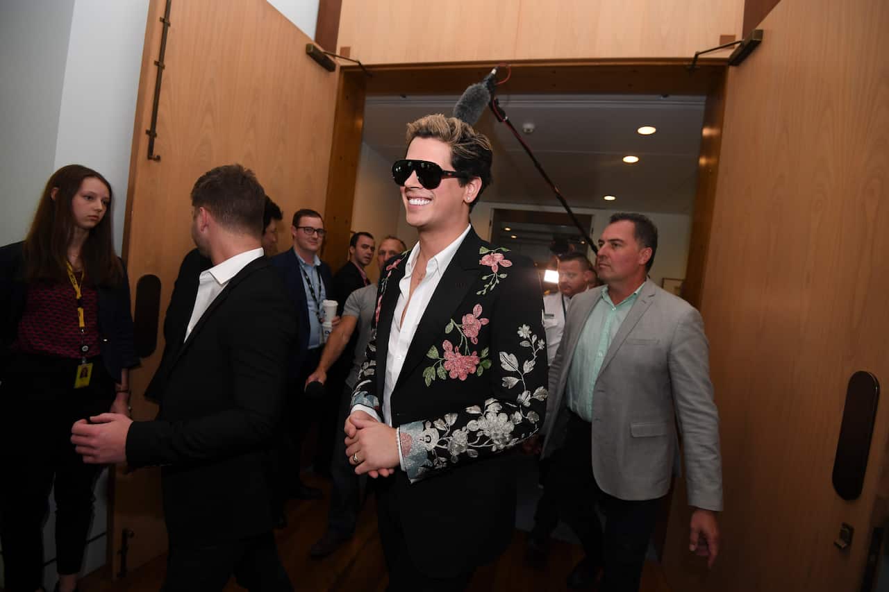 British alt-right commentator Milo Yiannopoulos leaves after speaking at an event at Parliament House in Canberra, Tuesday, December 5, 2017. (AAP Image/Lukas Coch) NO ARCHIVING