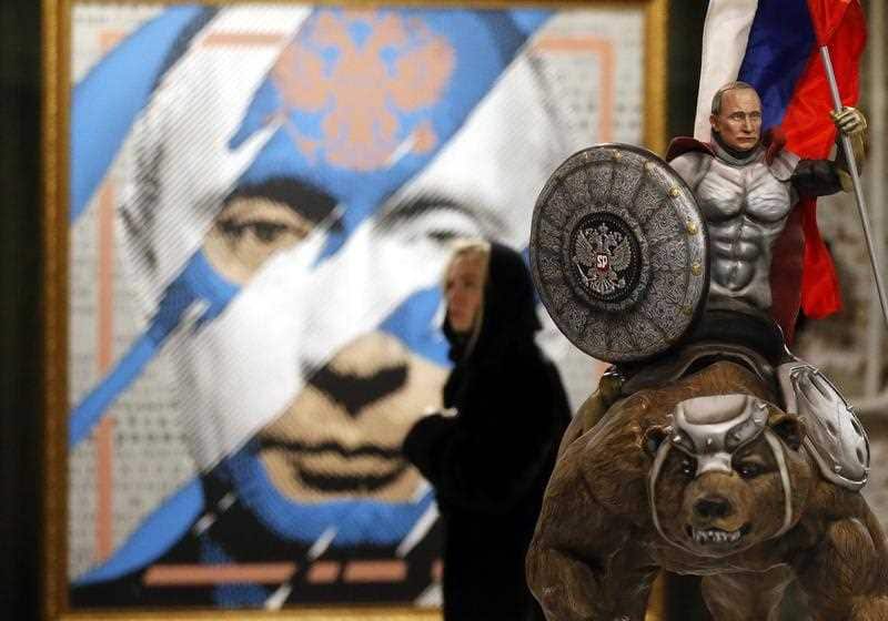 A visitor in front of an artwork depicting Russian President Vladimir Putin during the SUPERPUTIN exhibition at the Ultra Modern Art Museum (UMAM) in Moscow, Russia, 07 December 2017.