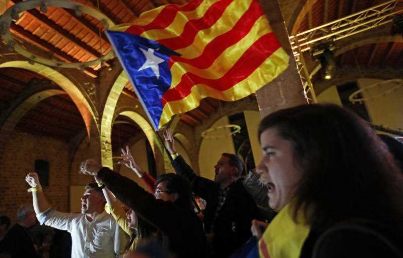 Catalan independence supporters wave a 'estelada' ( pro-independence Catalan flag ) celebrate at the ANC ( Catalan National Assembly ) headquarters after results of the regional elections in Barcelona, Spain, Thursday, December 21, 2017.