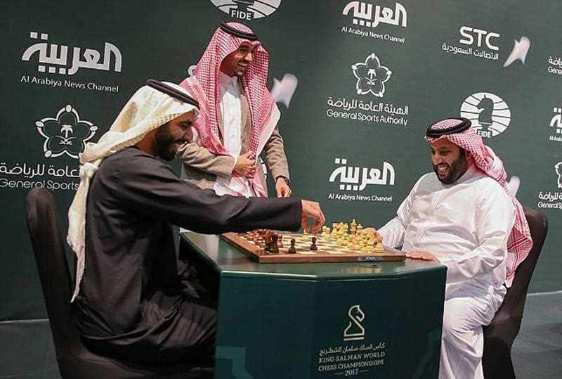 In this Monday, Dec. 25, 2017 photo released by Saudi Press Agency, two Saudi officials play chess during the opening the first ever chess tournament in Riyadh.