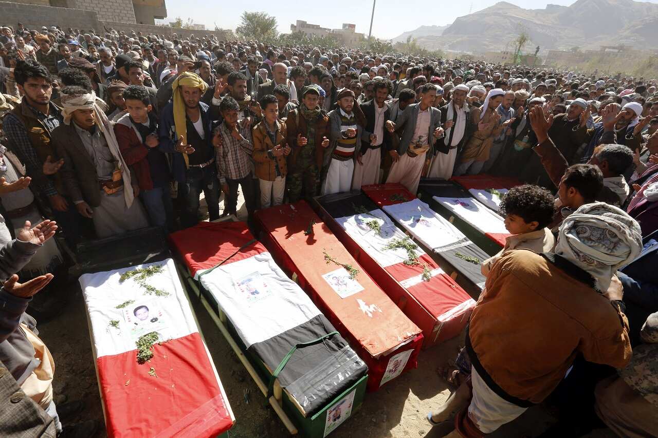 Yemenis gather around the coffins of victims of alleged Saudi-led airstrikes, during a funeral in Sana'a, Yemen, 26 December 2017.