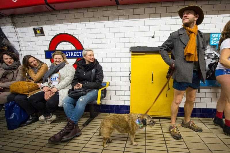 A man waits on the platform at Bond Street tube station as he takes part in No Trousers on the Tube day, in London.
