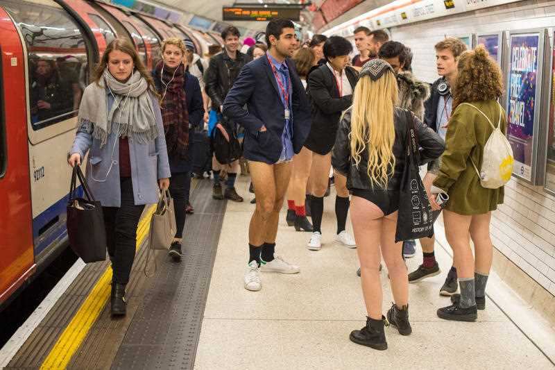 People wait on the platform at Liverpool Street tube station as they take part in No Trousers on the Tube day, in London.