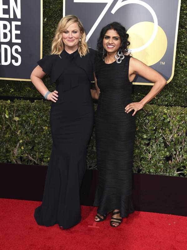 Amy Poehler, left, and Saru Jayaraman arrive at the 75th annual Golden Globe Awards at the Beverly Hilton Hotel on Sunday, Jan. 7, 2018, in Beverly Hills, Calif. 