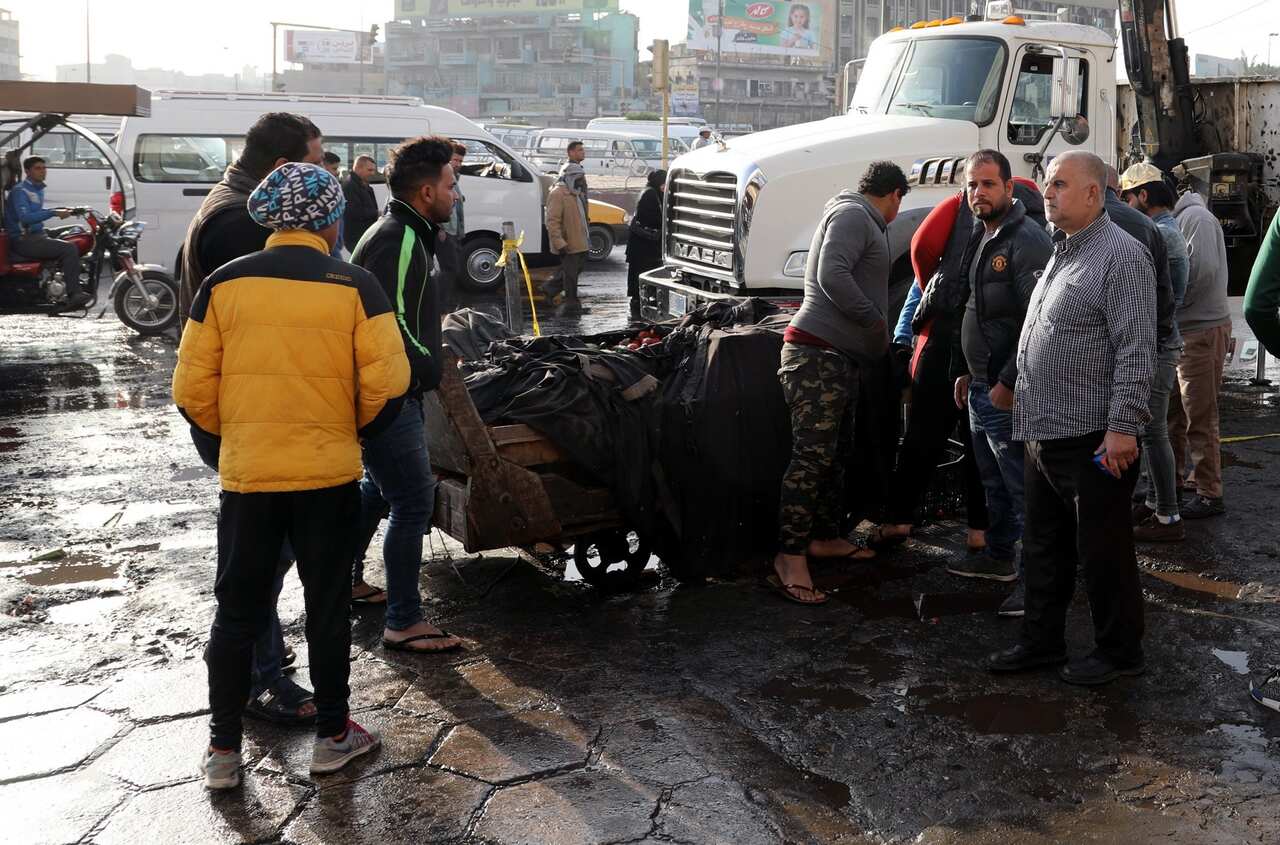 Iraqis gather at the site of a suicide bomb attack at Tayaran square in central Baghdad, Iraq, 15 January 2018. 