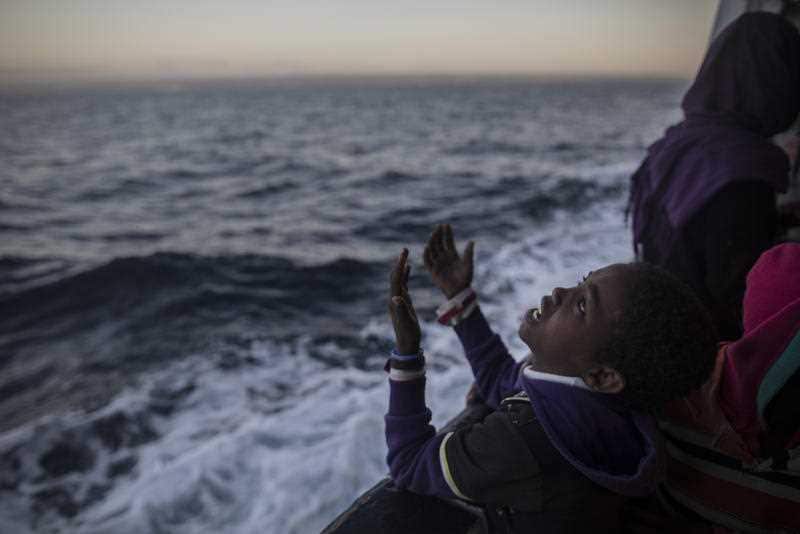 A child from Eritrea sings to celebrate his arrival to Europe aboard a Spanish migrant rescue ship.