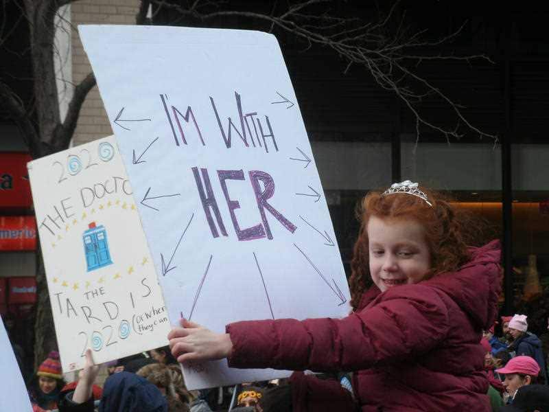 :A girl holds a sign-board as thousands participate in the Women's March on January 20, 2018 in New York City.