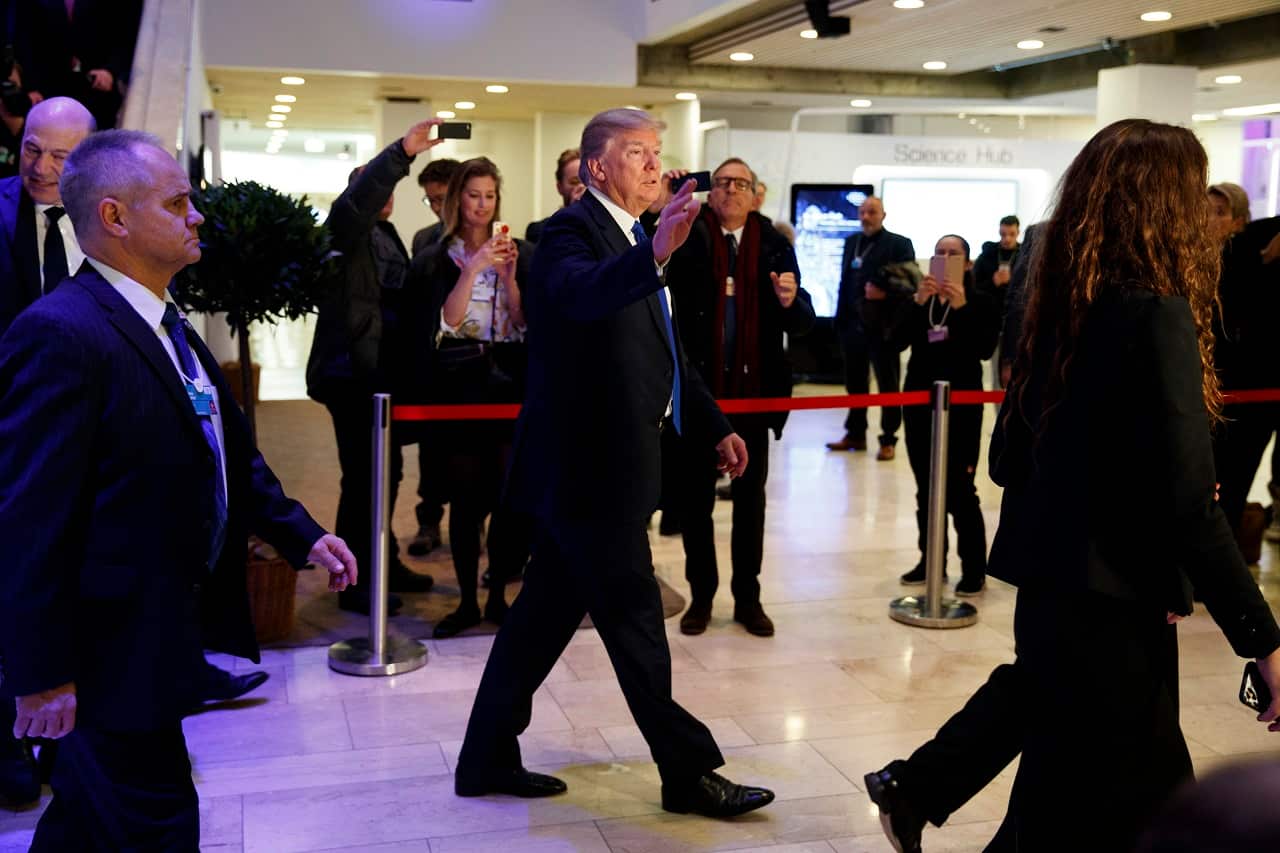 President Donald Trump waves as he walks to a dinner with European business leaders at the World Economic Forum in Davos.