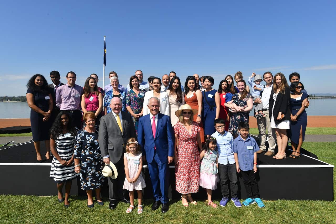 Prime Minister Malcolm Turnbull and Governor-General Peter Cosgrove pose with new Australian citizens after an Australia Day Citizenship Ceremony.
